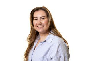 Beca Tackley paralegal legal assistant headshot wearing striped shirt with long brown hair and smiling