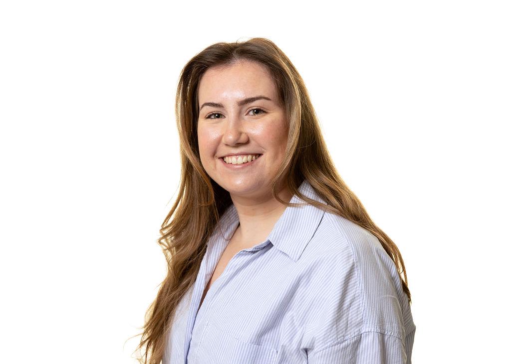 Beca Tackley paralegal legal assistant headshot wearing striped shirt with long brown hair and smiling